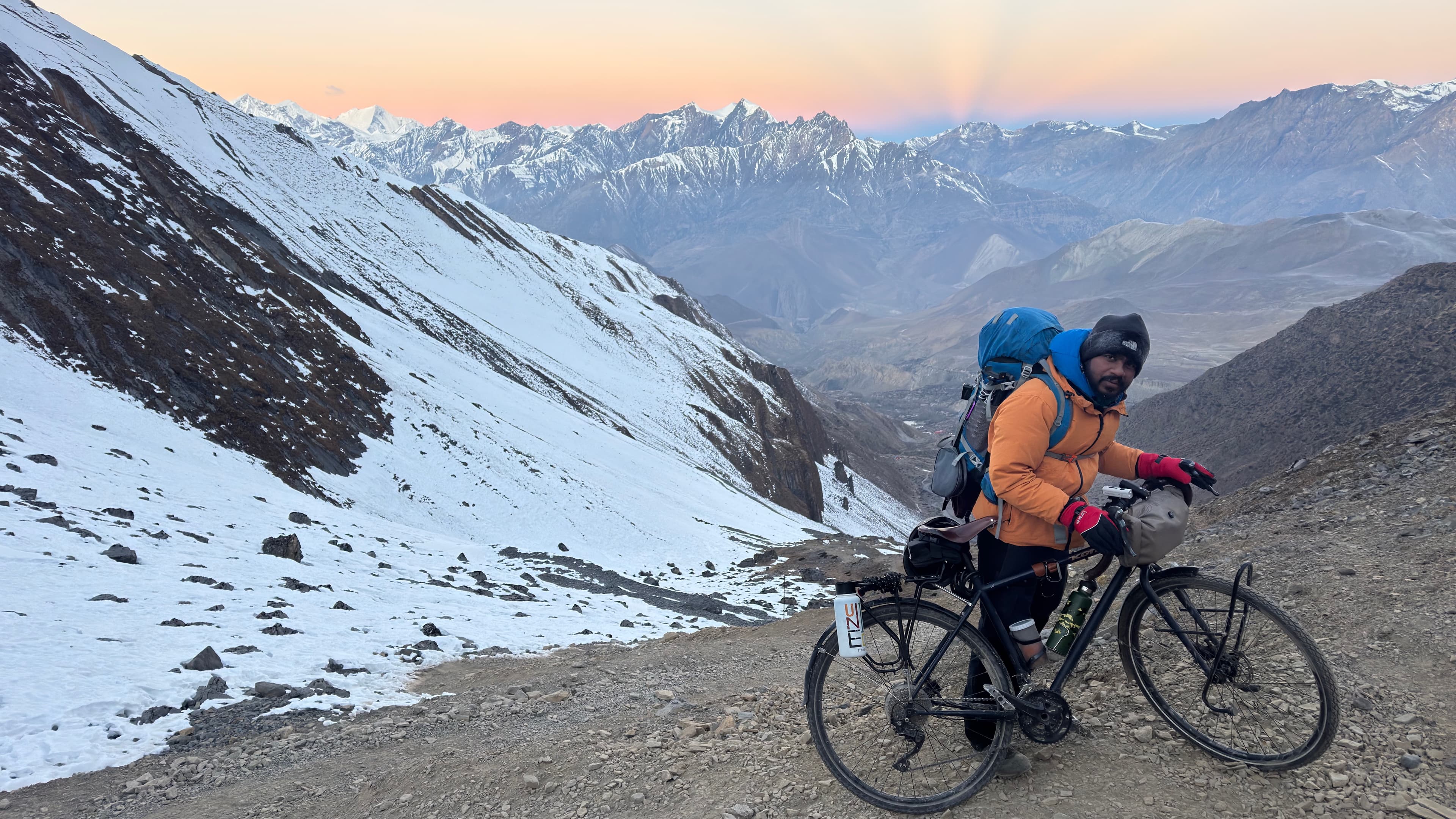 Cyclist riding through an open mountain stretch during the Thorong La winter attempt